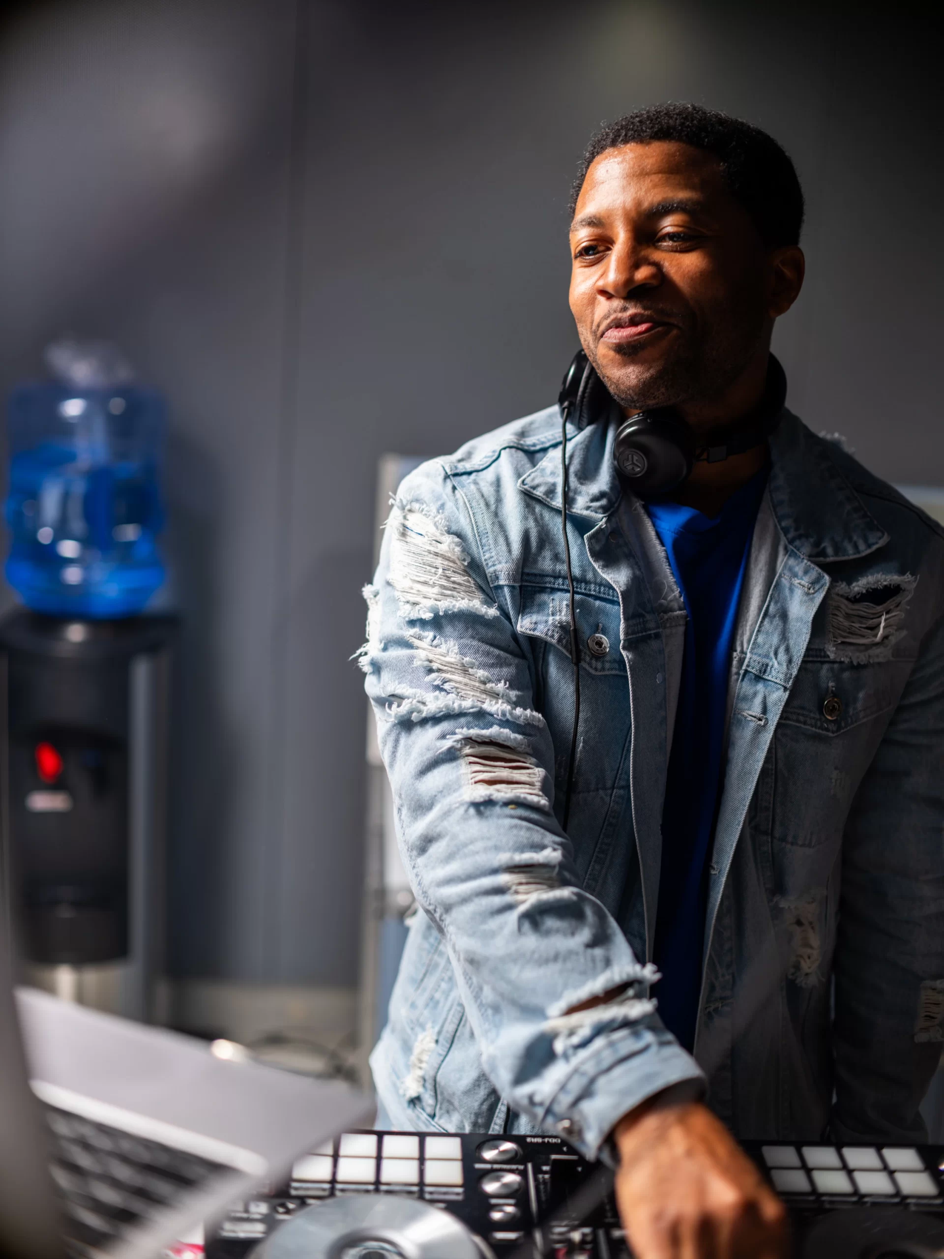 DJ Reese wearing headphones at the DJ decks during the 9/11 Day Meal Pack in New York City