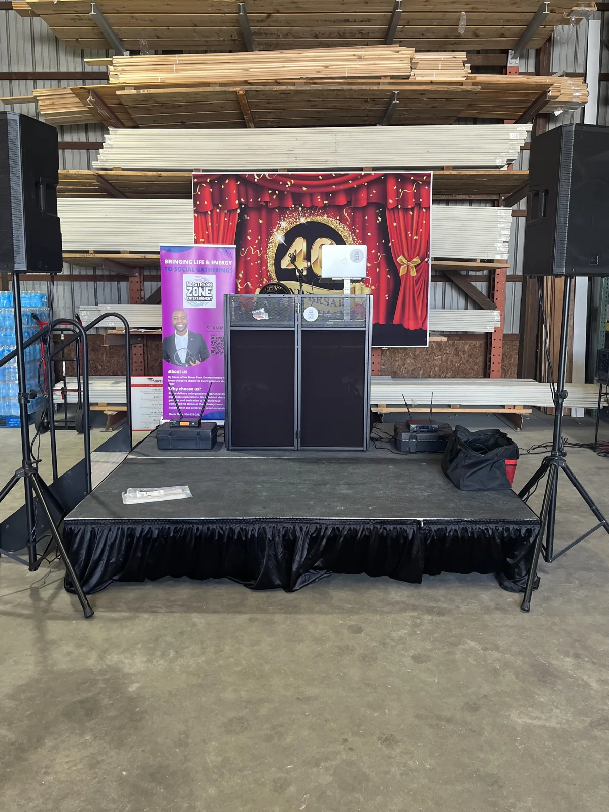 DJ Reese stage and sound setup with a 40th anniversary backdrop, American Cedar & Millwork, Lewes, Delaware
