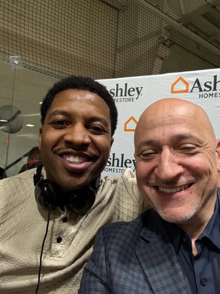 DJ Reese of No Stress Zone Entertainment with Michael Geraci, District Visual Merchandising Manager at Ashley HomeStore, at a Philadelphia event