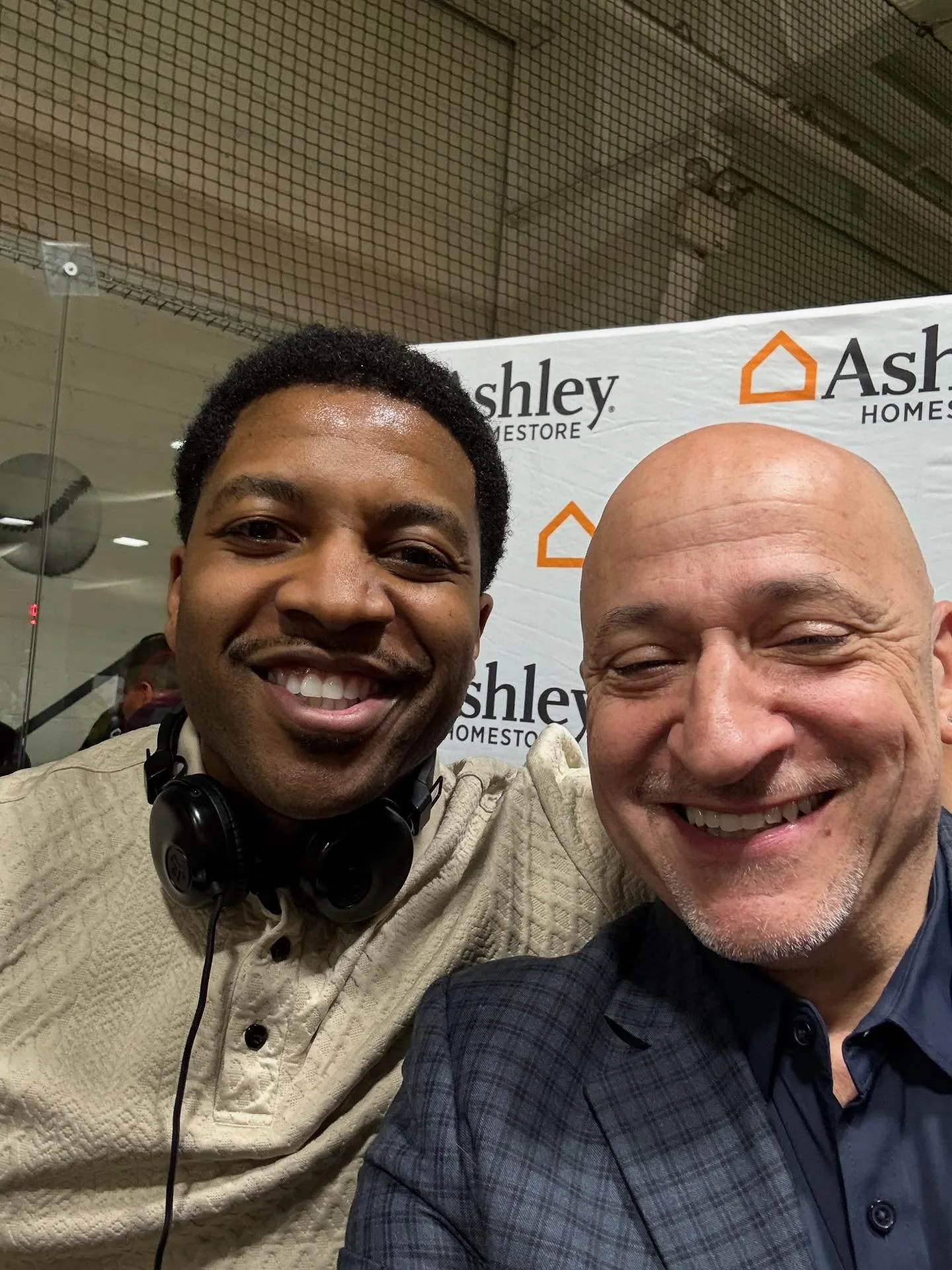 DJ Reese of No Stress Zone Entertainment with Michael Geraci, District Visual Merchandising Manager at Ashley HomeStore, at a Philadelphia event